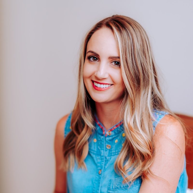 smiling girl in blue sleeveless dress